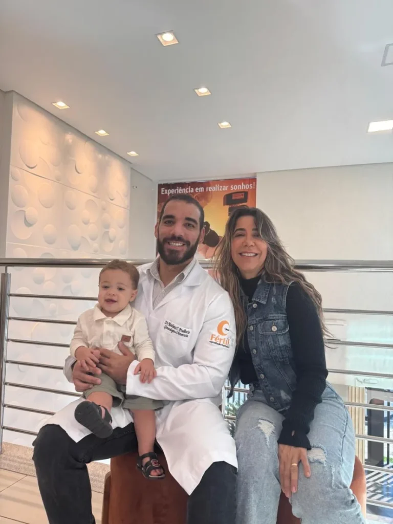 Casal com bebê ao lado de médicos da Fértil